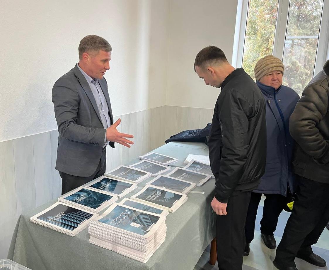 A man giving out training materials