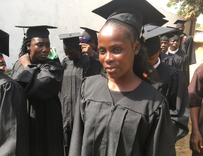 A Liberian girl, a graduate of a Bible school in her graduation robe