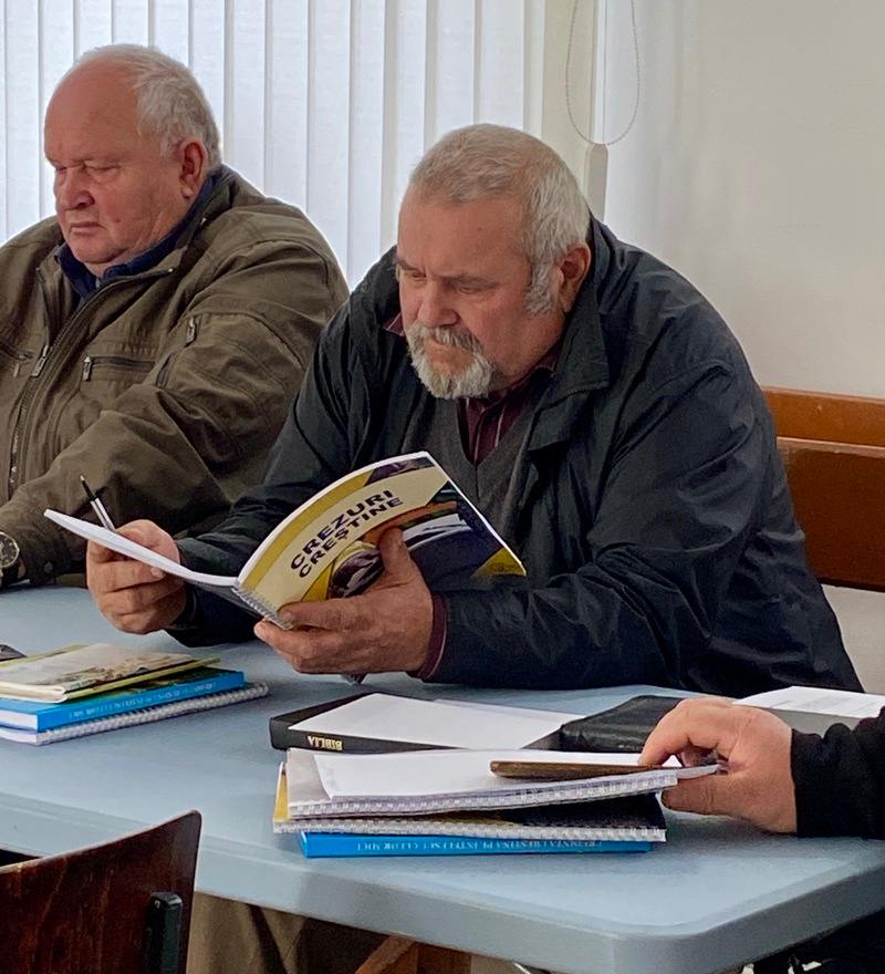 An adult student is reading a course book